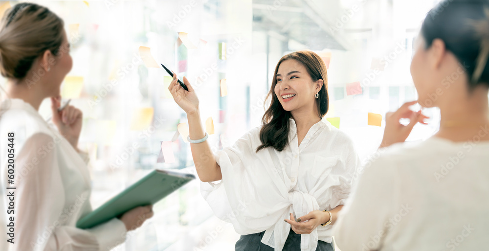 Creative business people using sticking notes on glass wall, persenting business plan. Creative business people using sticking notes on glass wall, persenting business plan.