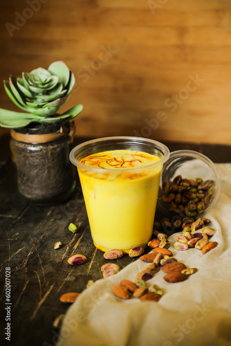 Badam sharbat, Almond milk syrup with saffron served in glass isolated on table top view of drink photo