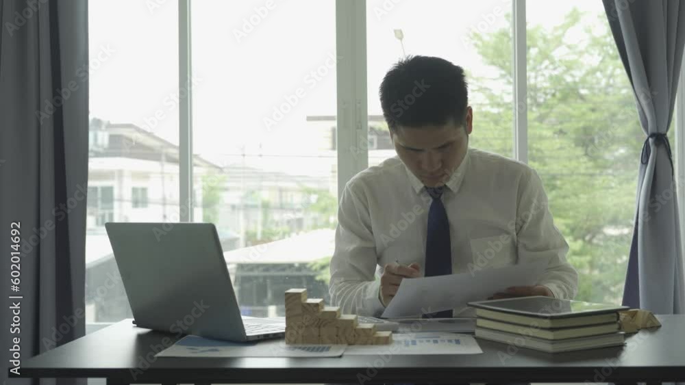 Asian male businessman working in real estate finance business success concept Asian male businessman working in real estate finance business success concept