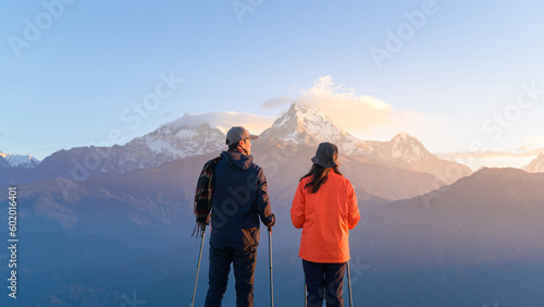 A young couple travellers trekking in Poon Hill view point in Ghorepani, Nepal. © tonefotografia