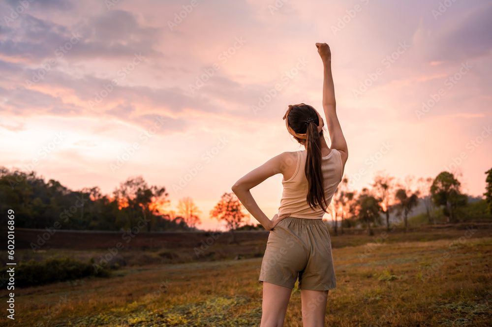 Silhouette woman over golden sunset background feeling happy successful in her life Silhouette woman over golden sunset background feeling happy successful in her life