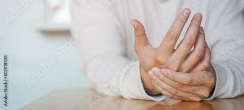 Obraz na plátně close up young man massage on his hand and arm for relief pain of stiff or cramp