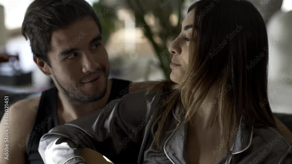 Man teaching woman hoy to play the guitar-Couple in love Man teaching woman hoy to play the guitar-Couple in love