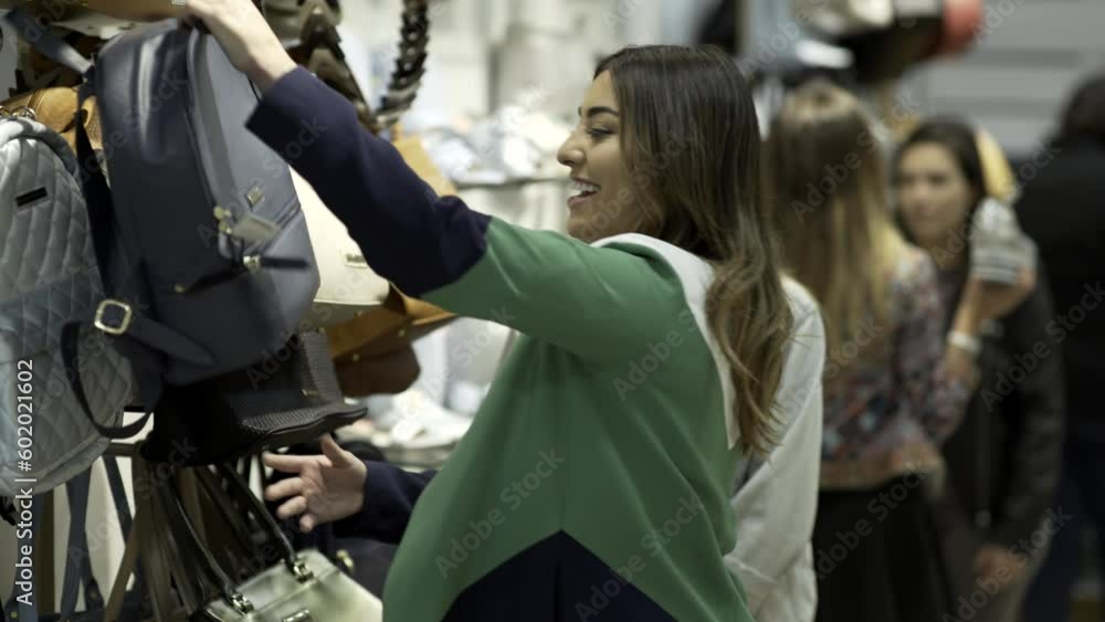Two young girls shopping at the mall-Choosing bags Two young girls shopping at the mall-Choosing bags