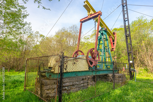 Pump jack for oil extraction in the village of Zatwarnica in the Bieszczady Mountains, Poland. photo