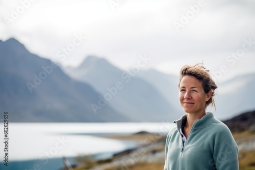 Mature woman standing in front of fjord in norway © Robert MEYNER