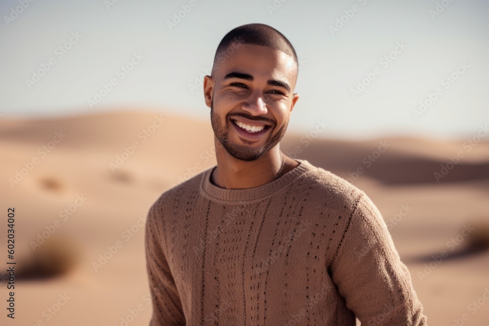Portrait of smiling young man standing in the middle of the desert Portrait of smiling young man standing in the middle of the desert