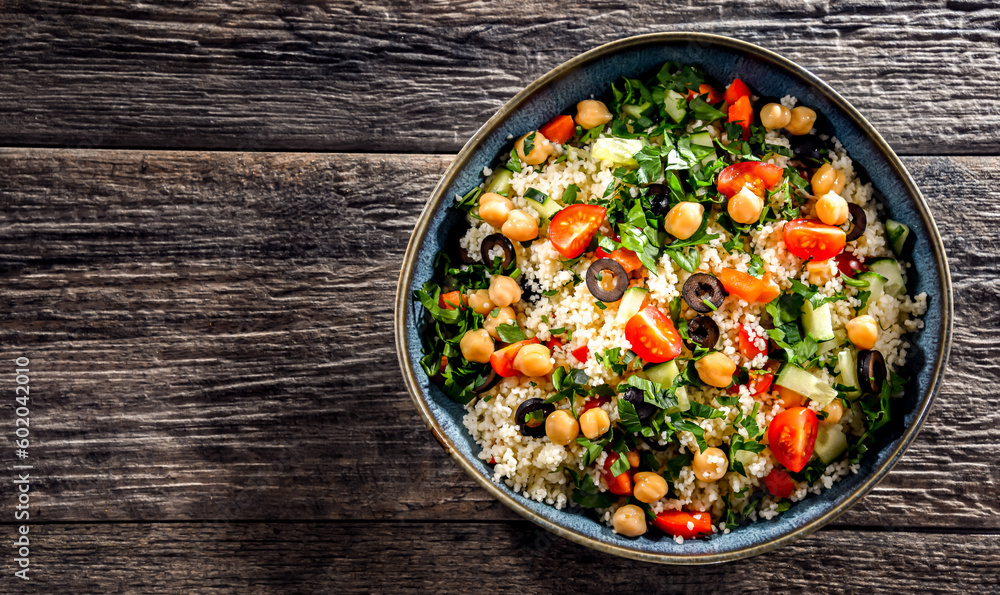 A plate of couscous served with vegetables and chickpeas A plate of couscous served with vegetables and chickpeas