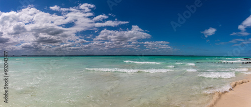 Panoramic view of a beautiful white sandy beach in the Caribbean Sea with beautiful turquoise colors under a blue sky. Caribbean beaches of golden sand under a tropical sun. Paradise beach concept.