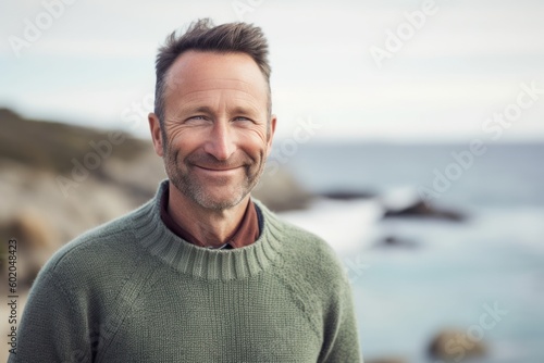 Portrait of smiling man standing at the beach on a sunny day