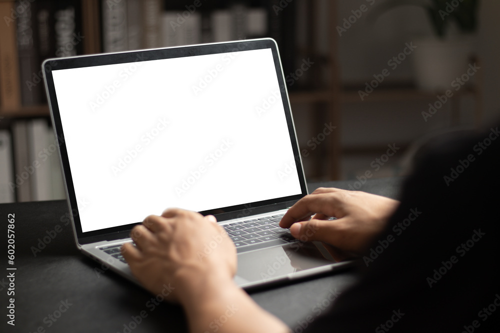 Mockup of man using and typing on laptop with blank white desktop screen. - obrazy, fototapety, plakaty 