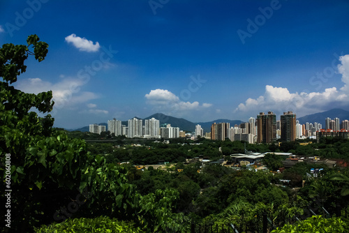 Hong Kong City view under the blue sky with forest, looking from the mountain. Travel and city scene.
