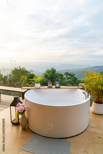 outdoor bath tub with beautiful mountain view background © topntp