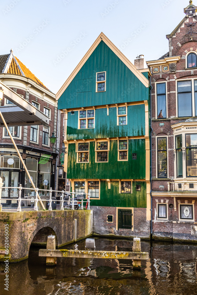 Obraz premium An old house with a wooden facade painted green. Alkmaar. Netherlands