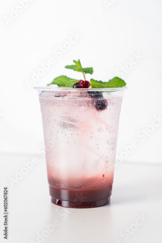 mix berry with soda in glass