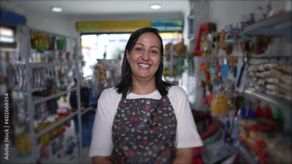 Happy Local Pet Shop Female Owner Portrait face close-up standing inside inside Store smiling. Woman wearing apron looking at camera Happy Local Pet Shop Female Owner Portrait face close-up standing inside inside Store smiling. Woman wearing apron looking at camera