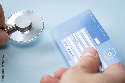 European health insurance card, doctor's office, Concept, EU document confirming the right to treatment outside of your own country, Travel insurance for Europeans traveling to EU and EFTA countries photo