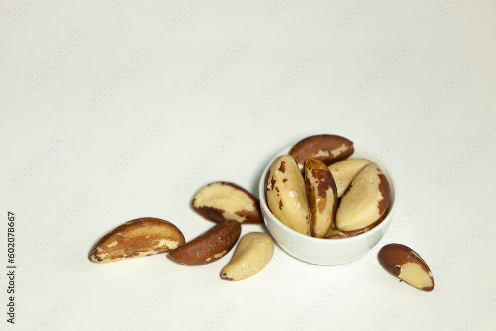 Brazil nuts in a small white bowl.