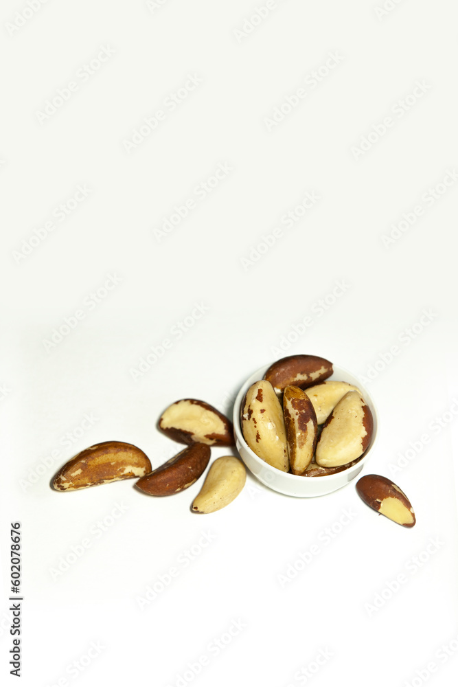 Brazil nuts in a small white bowl.