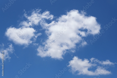 Blue sky background with white clouds closeup © Leonid