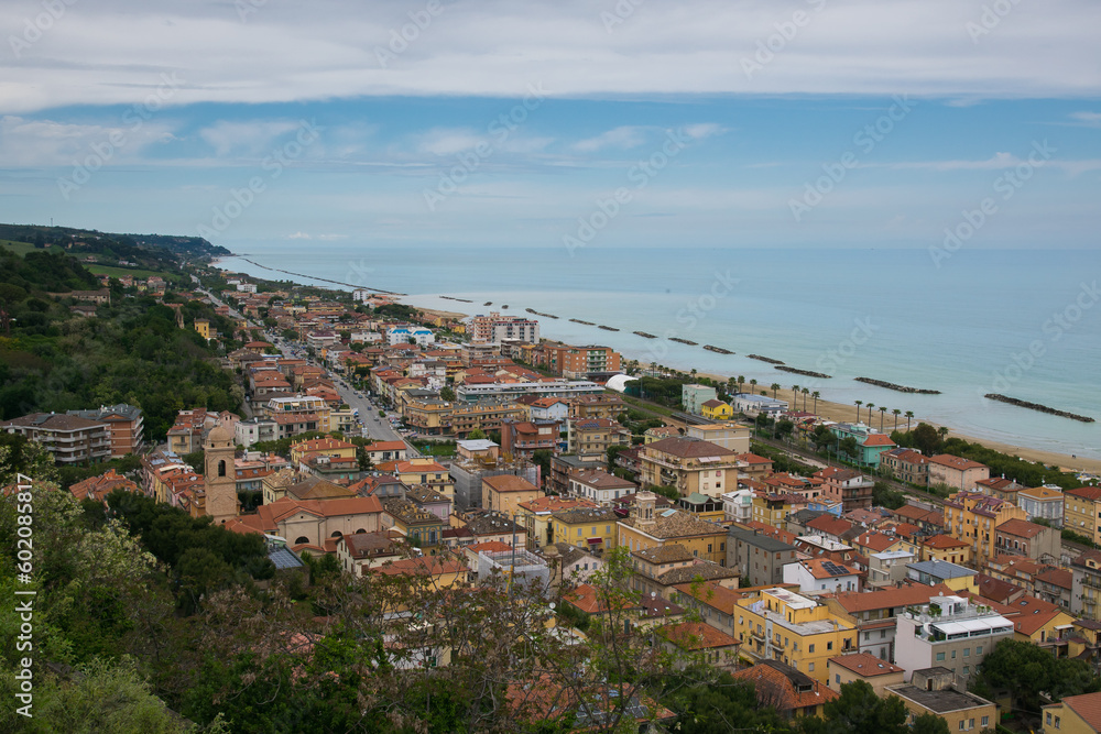 Aerial view from Cupra Alta (Marano) at the modern Italian town of Cupra Marittima located between hills with green trees and the Adriatic sea, Marche region, Europe