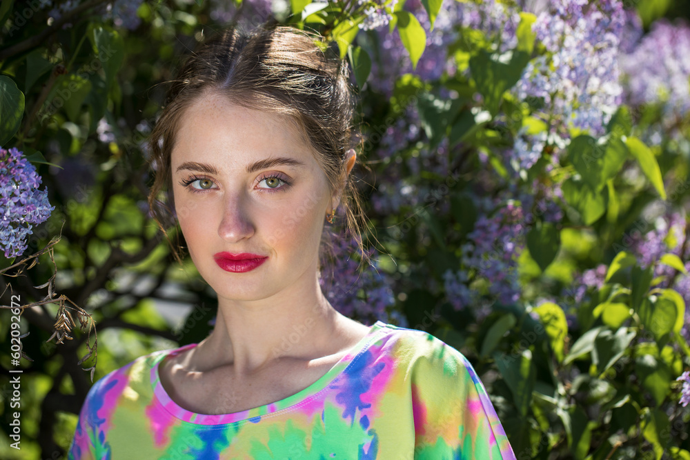 Young beautiful woman posing in lilac bushes Young beautiful woman posing in lilac bushes