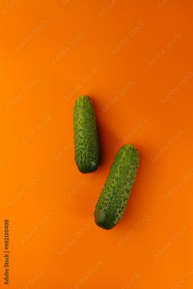 on a bright orange background, a blue sewing centimeter and various healthy vegetables arugula cucumbers lemon. for banners, intros, advertising labels and more on a bright orange background, a blue sewing centimeter and various healthy vegetables arugula cucumbers lemon. for banners, intros, advertising labels and more