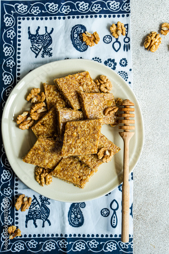 Overhead view of a plate of traditional Georgian honey and walnut brittle (gozinaki) on a  traditional tablecloth photo