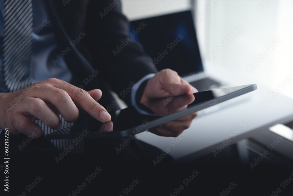 Close up, business man using digital tablet, finger touching on blank screen, mockup tablet pc. Business man surfing the internet at office Close up, business man using digital tablet, finger touching on blank screen, mockup tablet pc. Business man surfing the internet at office