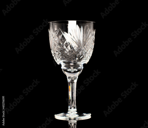 One crystal wine glass, macro, isolated on black background.