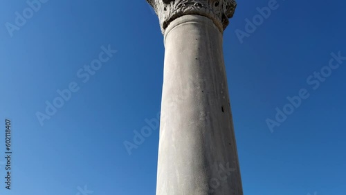 Close-up view of white marble Ancient Greek Column against clear blue sky. Soft focus. Mediterranean culture theme.