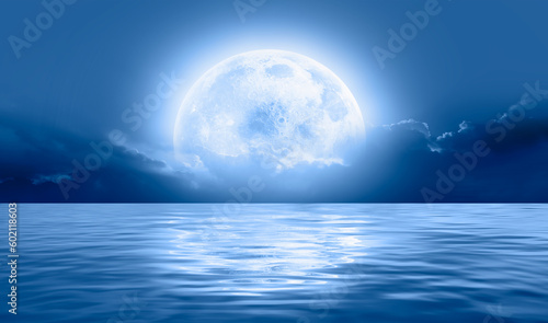 Night sky with full bright moon in the clouds  Elements of this image furnished by NASA 