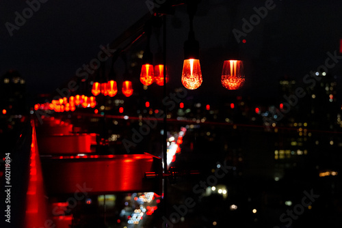 A rooftop with red lights for Chinese New Year. Intentional bokeh of lights and street below.