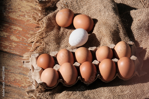 Brown eggs in a box. Farm food product. Beautiful sunny background with eggs.