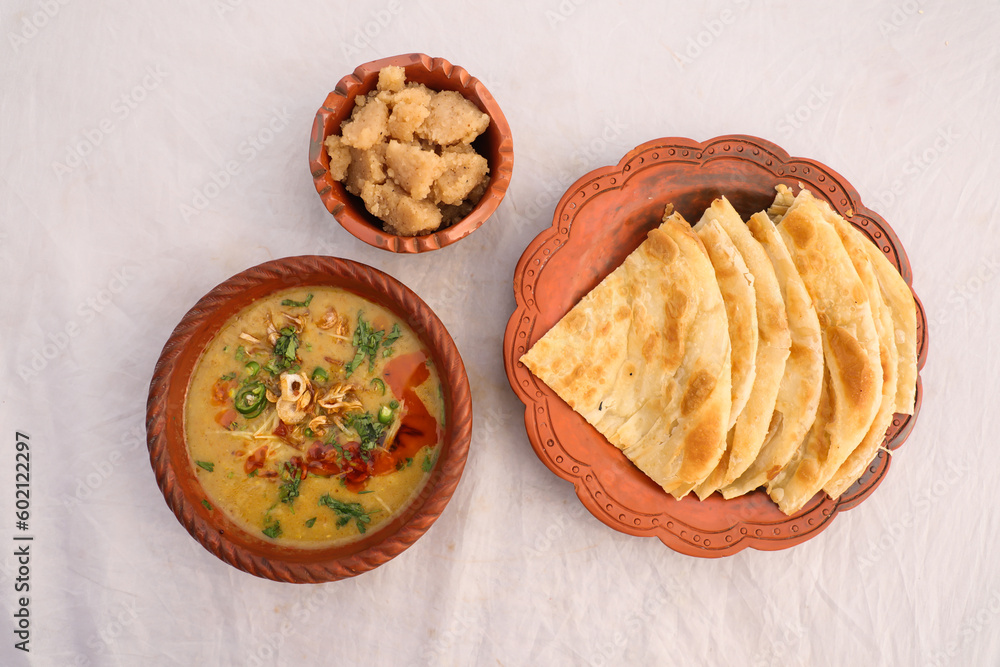 Desi breakfast, haleem, halim, dhaleem, halwa and paratha served in ...