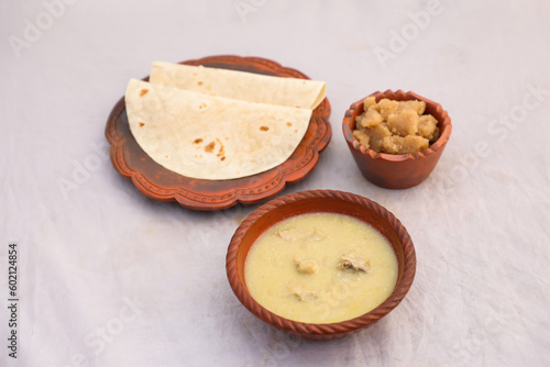 desi breakfast Chicken soup, Halwa and chapatti served in dish isolated on background top view of bangladesi breakfast