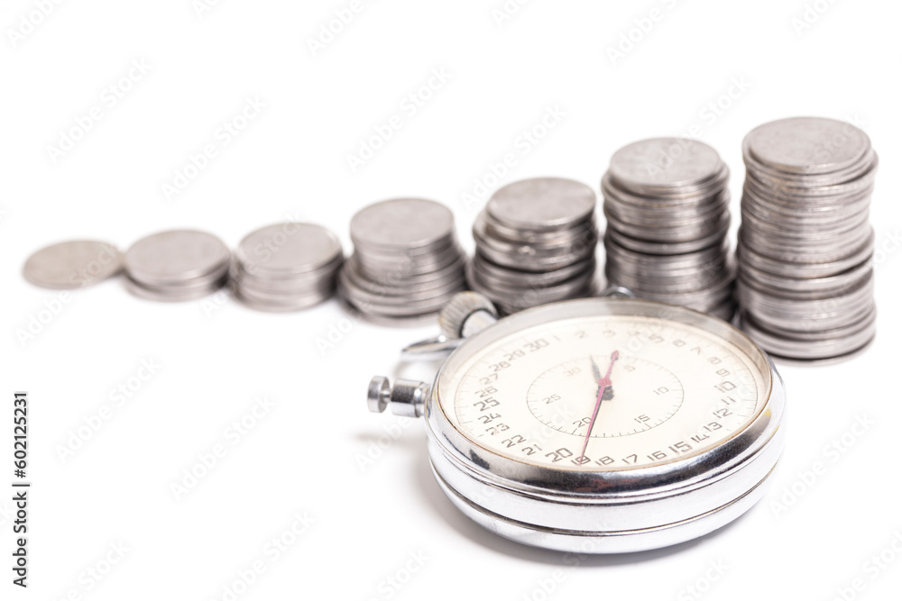 Time is money. Stopwatch and stacks of coins Time is money. Stopwatch and stacks of coins