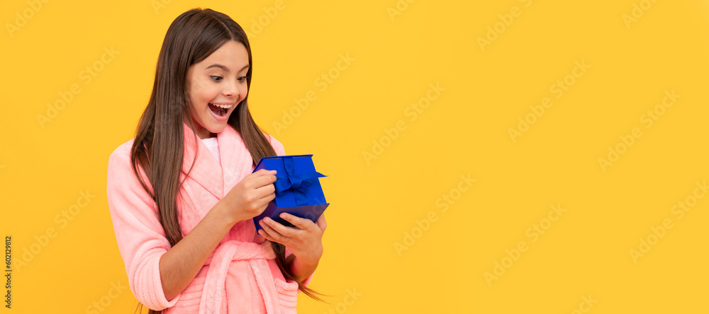 surprised teen girl in home terry bathrobe open gift or present box, surprise. Child with birthday gift, horizontal poster. Banner header with copy space. surprised teen girl in home terry bathrobe open gift or present box, surprise. Child with birthday gift, horizontal poster. Banner header with copy space.