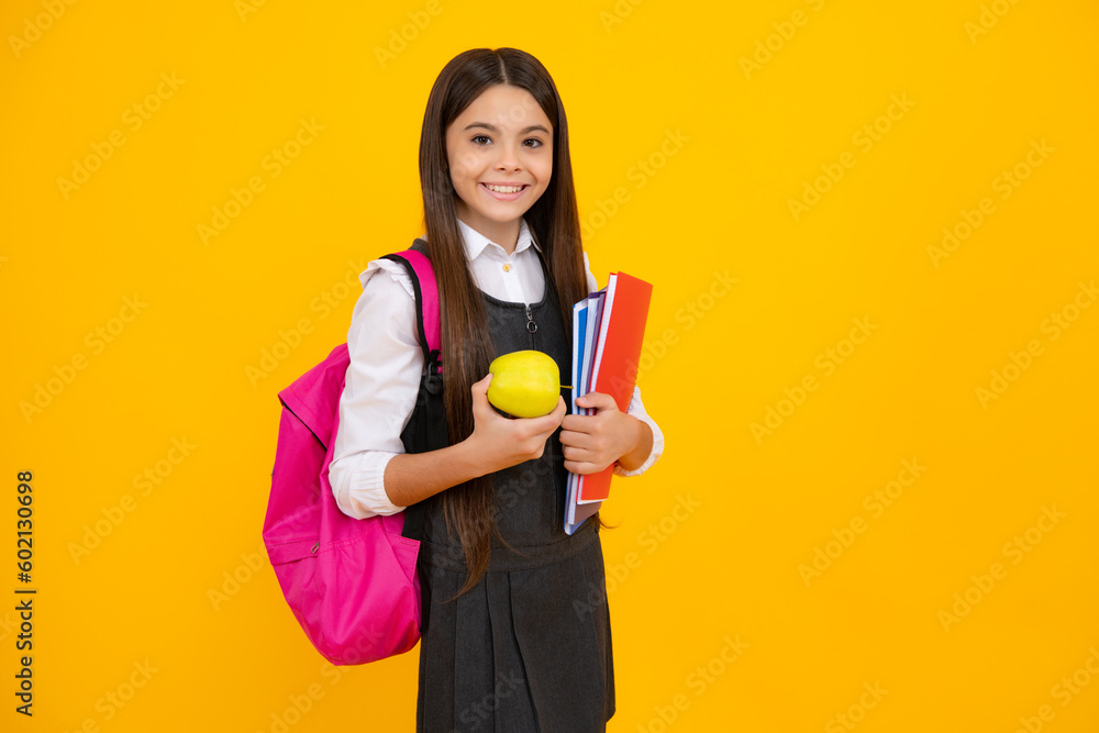 Schoolchild, teenage student girl with school bag backpack hold aplle and books on yellow isolated studio background. Children school and education concept. Schoolchild, teenage student girl with school bag backpack hold aplle and books on yellow isolated studio background. Children school and education concept.
