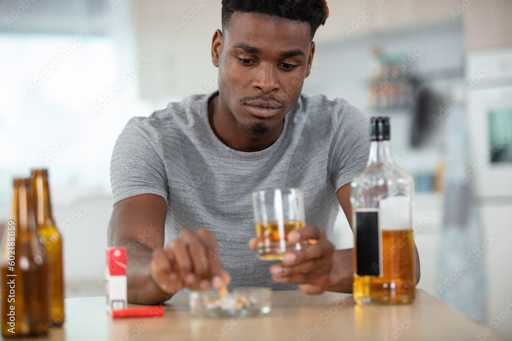 depressed man abusing of alcohol trying to forget his problems