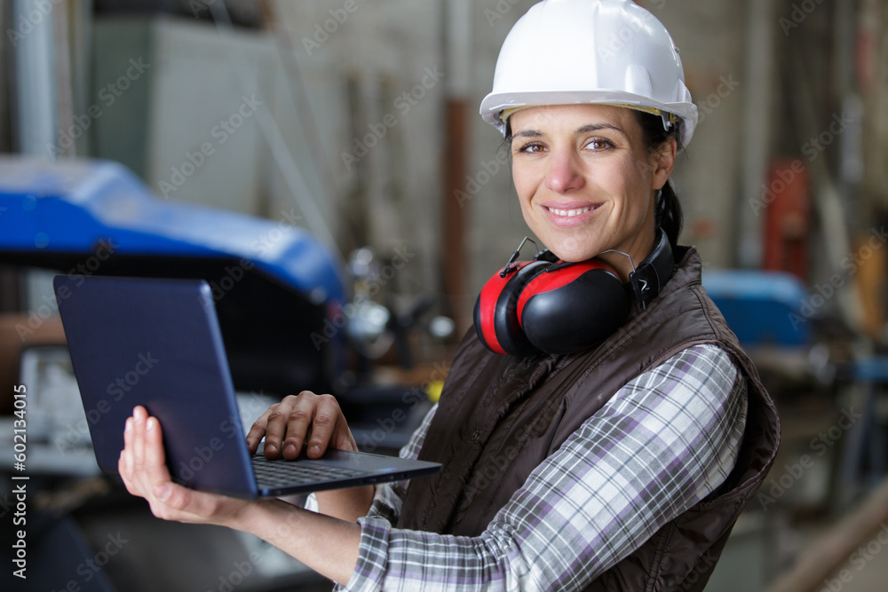 male female industrial engineers in hard hats using laptop male female industrial engineers in hard hats using laptop