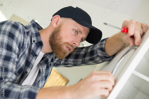 a man is drilling the door