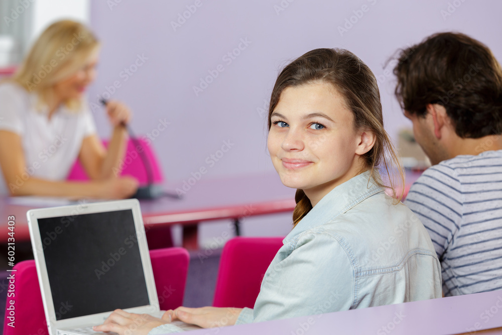 happy student with computers studying at school happy student with computers studying at school
