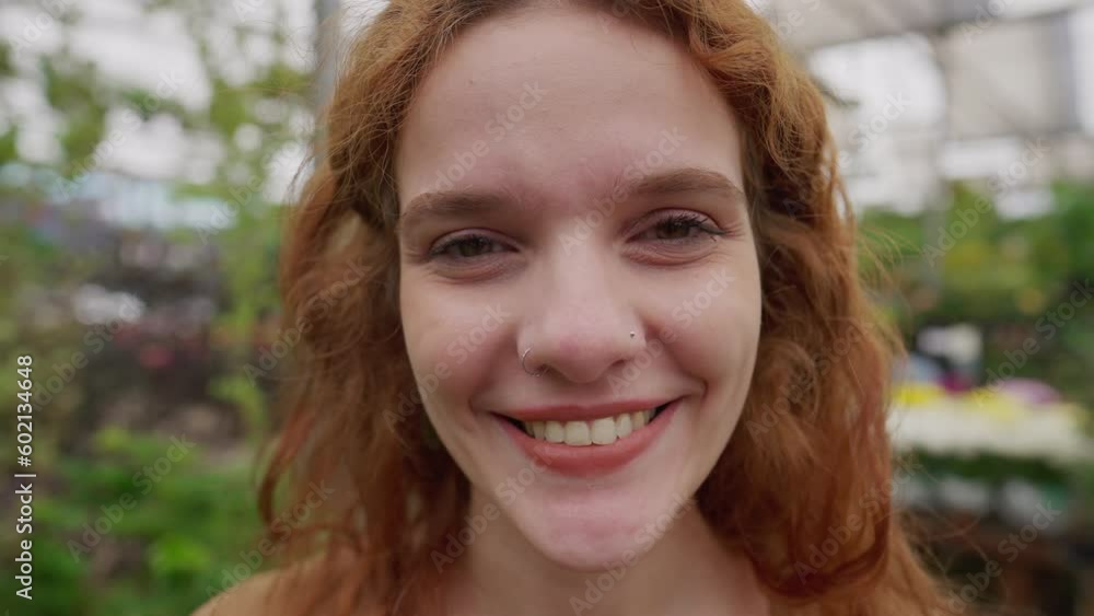 Happy Young Redhead Woman: Smiling at Camera Inside Natural Green Environment. Close-Up Portrait of Female in 30s Happy Young Redhead Woman: Smiling at Camera Inside Natural Green Environment. Close-Up Portrait of Female in 30s