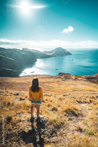 High angle view of tourist on a hill overlooking the coastal landscape of Madeira Island in the Atlantic Ocean in the morning. São Lourenço, Madeira Island, Portugal, Europe. © Michael
