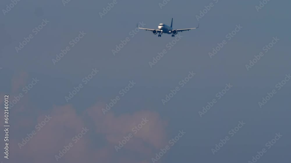 Passenger flight arrival. Plane approaching to land in cloudy sky. Airliner flies, background sky. Tourism and travel concept Passenger flight arrival. Plane approaching to land in cloudy sky. Airliner flies, background sky. Tourism and travel concept