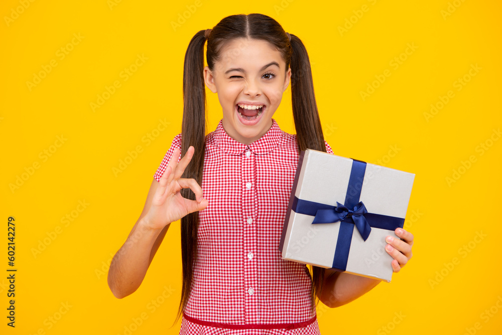 Emotional teenager child hold gift on birthday. Funny kid girl holding gift boxes celebrating happy New Year or Christmas. Happy teenager, positive and smiling emotions of teen girl. Emotional teenager child hold gift on birthday. Funny kid girl holding gift boxes celebrating happy New Year or Christmas. Happy teenager, positive and smiling emotions of teen girl.