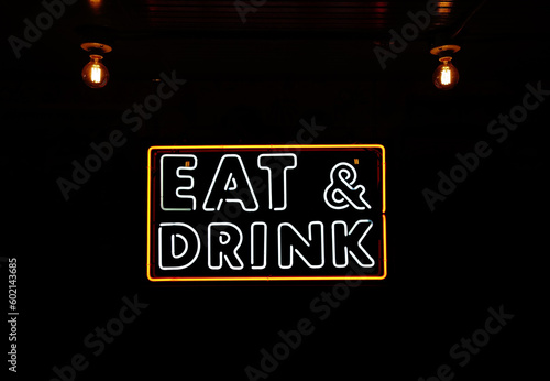 Eat and Drink neon sign with vintage lightbulbs and ceiling