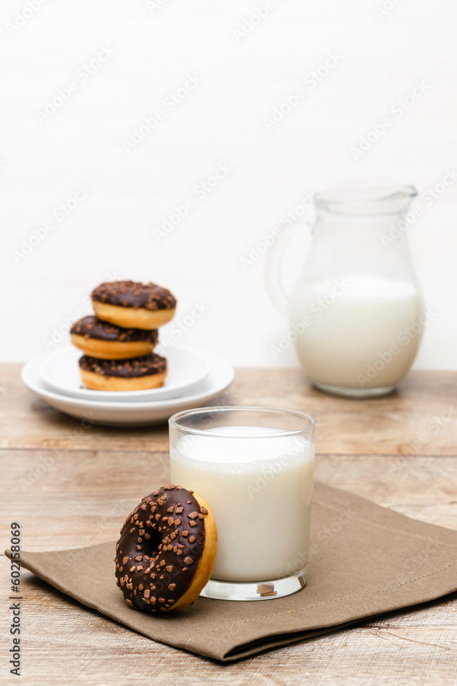 Mini donuts with chocolate glaze served with glass of milk.tasty sweet creamy doughnuts dessert food Mini donuts with chocolate glaze served with glass of milk.tasty sweet creamy doughnuts dessert food