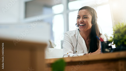 Laughing, virtual assistant or happy woman in call center consulting, speaking or talking at help desk. Smile, friendly or funny sales consultant in telemarketing customer services or telecom company photo
